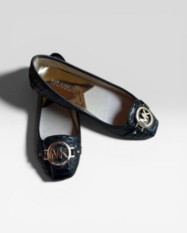 Michael Kors black leather pumps with gold logo hardware in excellent condition.
